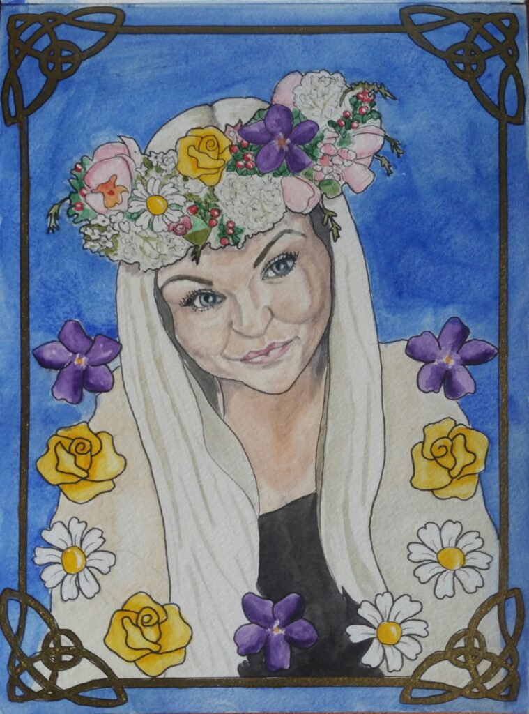 ID painting of young blonde woman wearing floral headdress she has Daisies, Violets and Roses surrounding the bottom half of her picture and they also feature in her headdress. she is wearing a black tshirt with cream cardigan over the top. The background is deep blue and the picture is framed by a gold celtic cornered border.