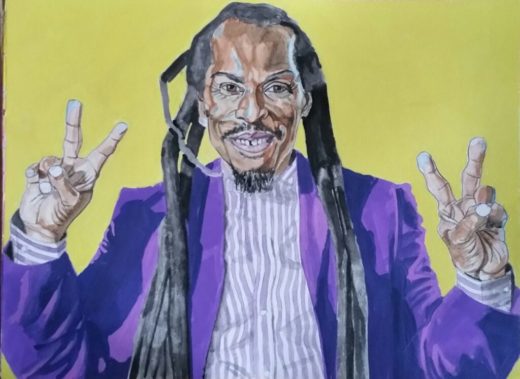 ID - Benjamin Zephaniah portrait, he has black skin tones with blue highlights and is wearing a striped purple and white shirt, with a purple jacket, he has very long dreadlocks, he is on a bright yellow background he is pictured to approx waist height and has his hands raised with two fingers on each hand showing the peace sign .