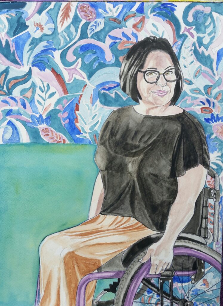 ID Watercolour portrait of a woman sat in a wheelchair, she is smiling, she has black bobbed hair and is wearing black glasses a blacks short sleeved top and gold skirt, behind her from shoulder height upwards is a floral pattern that fills the top half and right hand side of the painting - her wheelchair is black with a purple frame.