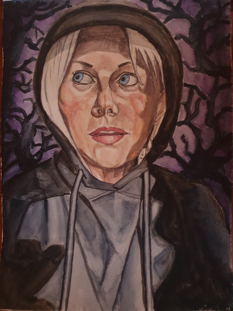 ID Woman wearing black and grey hoodie, she has white blonde hair and large blue eyes and her hood is up. Behind her is a spooky back ground of dark grey tree branches on a grey and purple background