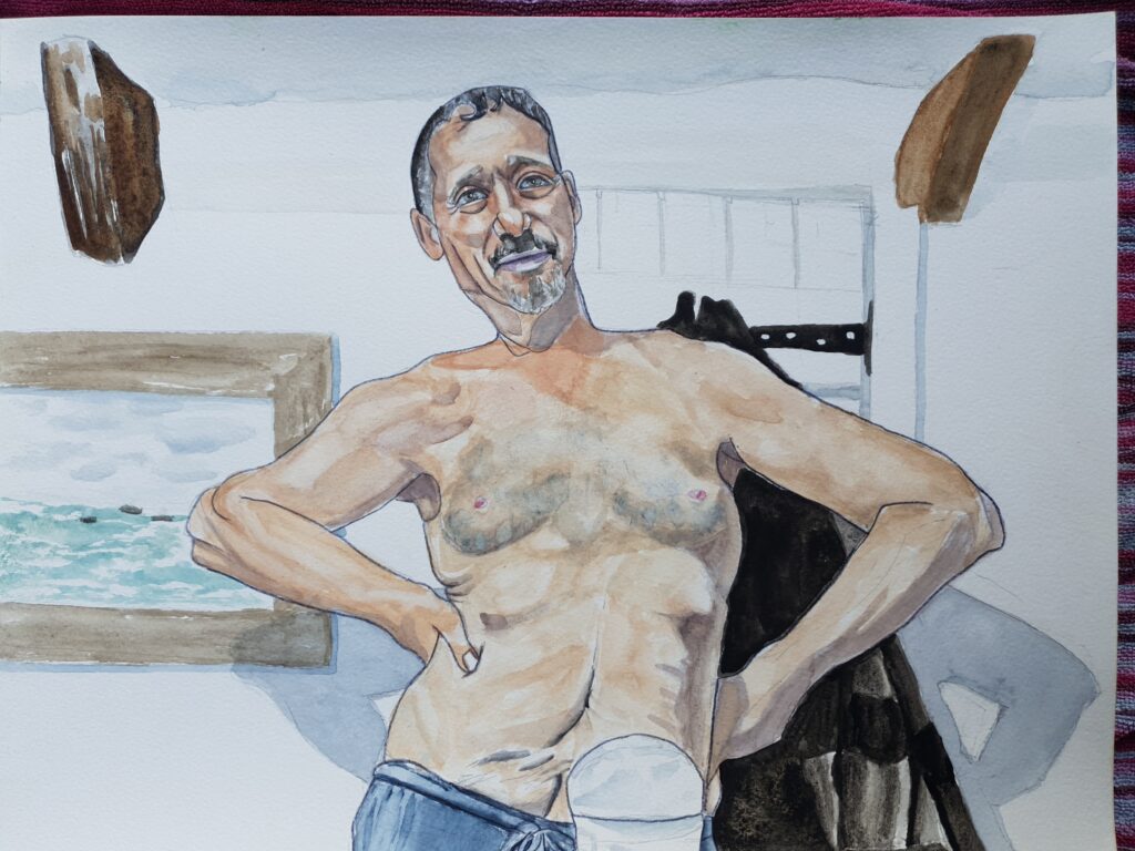 ID painting of Middle aged man stood with his hands on his waist. He has very kind eyes and a jovial face. He has a dark moustache and hair with flecks of grey in it and a grey goatee beard. He is topless and scars can be seen below his belly button and he is wearing a colostomy bag. Behind him is a dressing gown hanging on the door and their is a framed painting of a sea view on the wall behind him. Wooden supports can be seen in the corner between the walls and the roof on either side of the painting at the top.