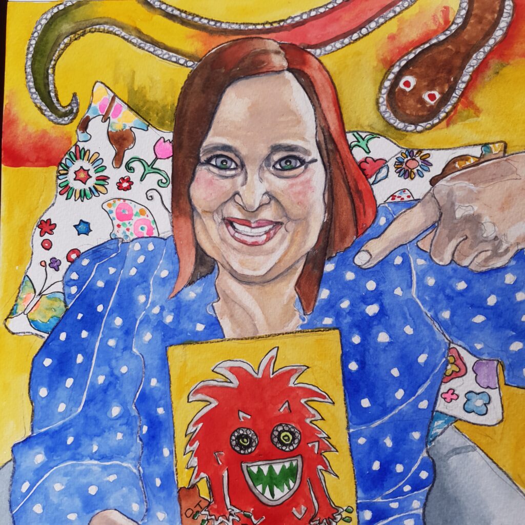 ID Watercolour painting of woman who is smiling, she has mid length bobbed reddish hair and is wearing a blue dress. She is pointing at a painting she has done which is described in the comments. Behind her is a a white pillow with flower and butterfly patterns on it,. She is sat in a grey chair. On the wall behind her is a painting of a snake which is brown, red, yellow and green and edged with white dots. The background is mainly yellow